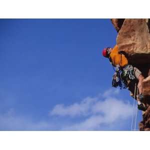  A Rock Climber Climbing up a Steep Rock Face Premium 