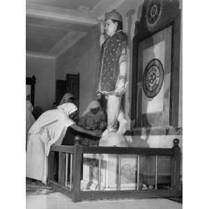  Hindu Women with their Children Praying at the Idol of 