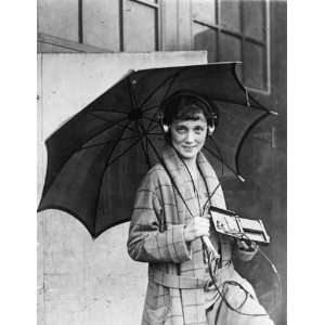  1922 photo Woman listening to pocket radio set while 